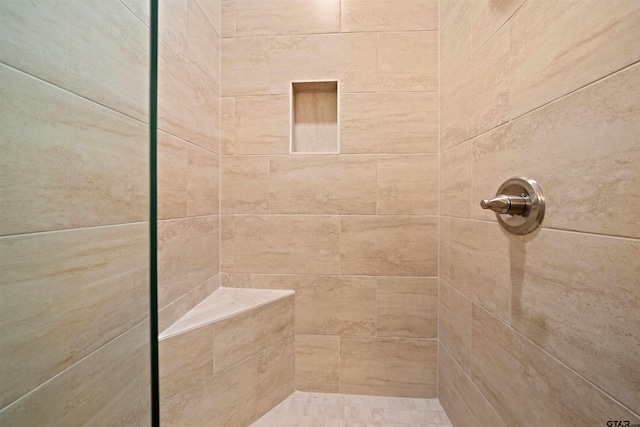 bathroom with a tile shower