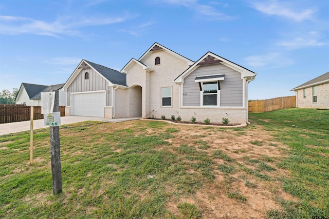 view of front of home featuring a garage and a front lawn