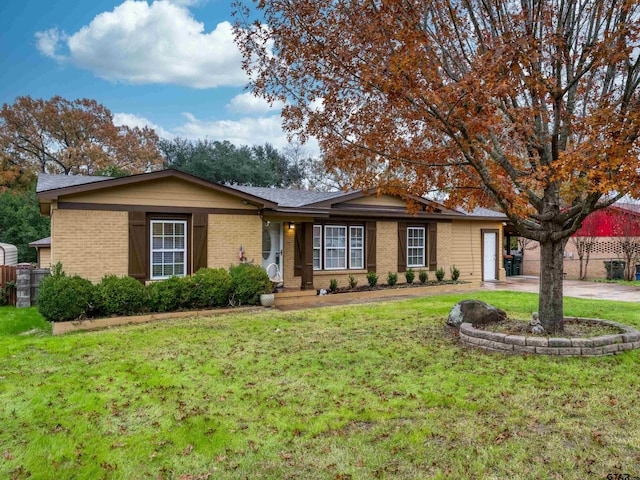 ranch-style home with a garage and a front yard