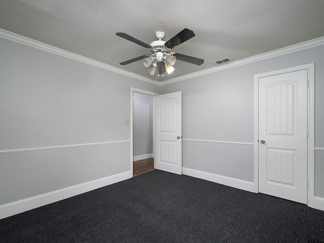 unfurnished bedroom featuring ceiling fan, crown molding, a textured ceiling, and dark colored carpet