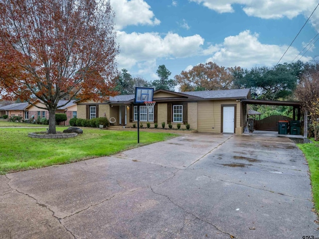 ranch-style house featuring a carport and a front yard