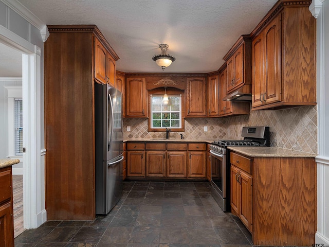 kitchen featuring backsplash, sink, light stone countertops, and stainless steel appliances