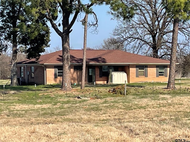 ranch-style house with brick siding and a front yard