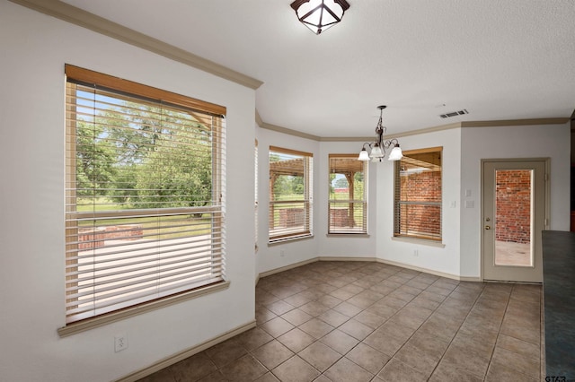 1745 County Road 1570, Alba, TX 75410 - unfurnished dining area with a chandelier, tile patterned flooring, ornamental molding, baseboards, and a textured ceiling
