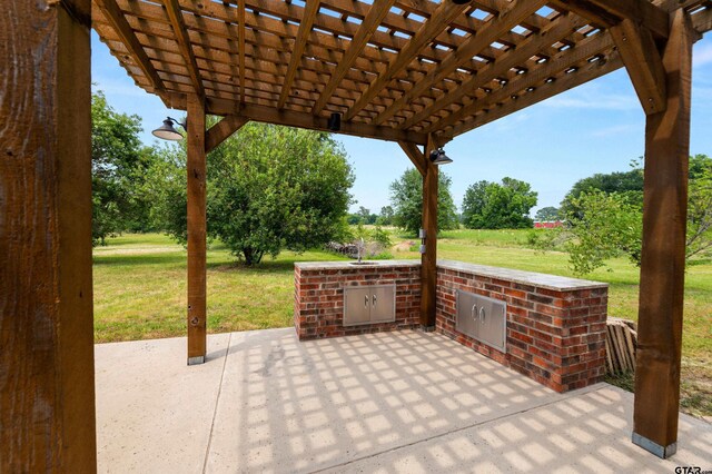 1745 County Road 1570, Alba, TX 75410 - view of patio with an outdoor kitchen and a pergola