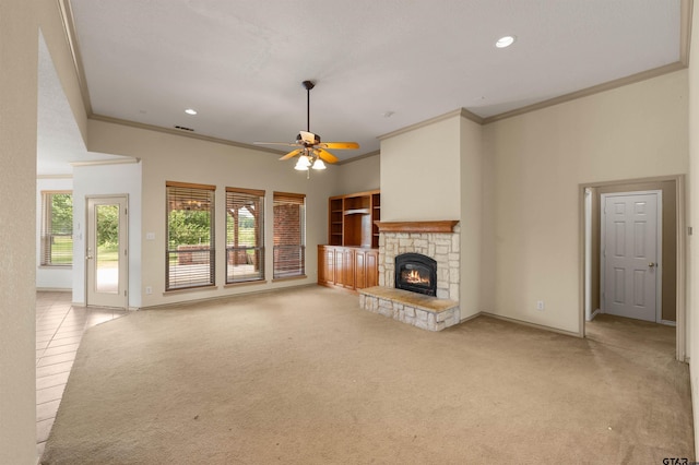 1745 County Road 1570, Alba, TX 75410 - unfurnished living room featuring crown molding, a stone fireplace, ceiling fan, carpet floors, and baseboards