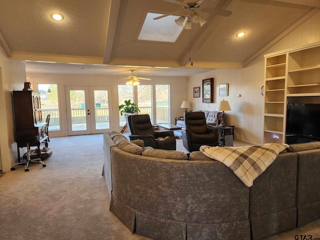 carpeted living area featuring recessed lighting, french doors, vaulted ceiling with beams, and a ceiling fan