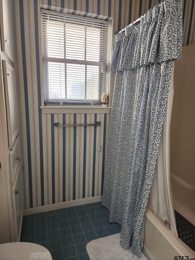 bathroom featuring tile patterned flooring and shower / bath combo