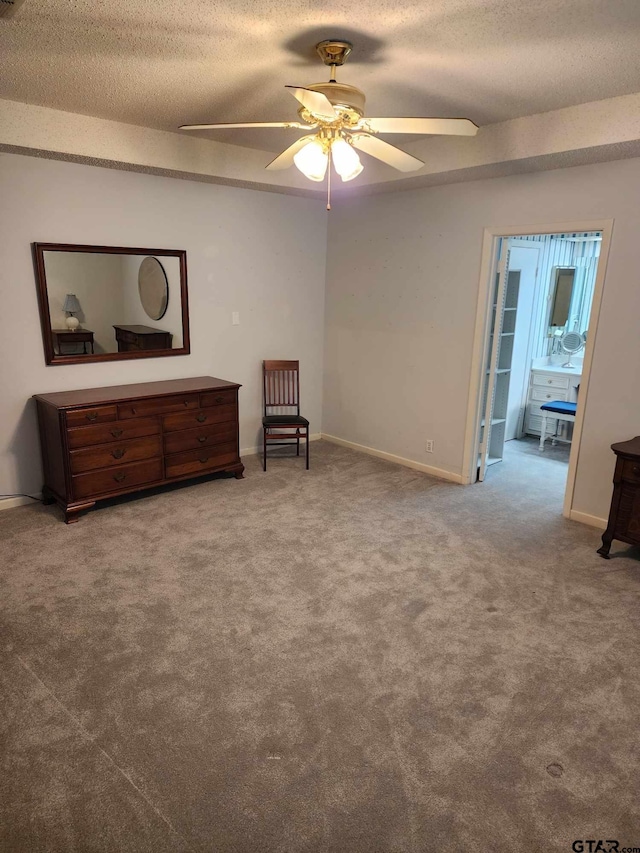 living area with ceiling fan, carpet, and a textured ceiling