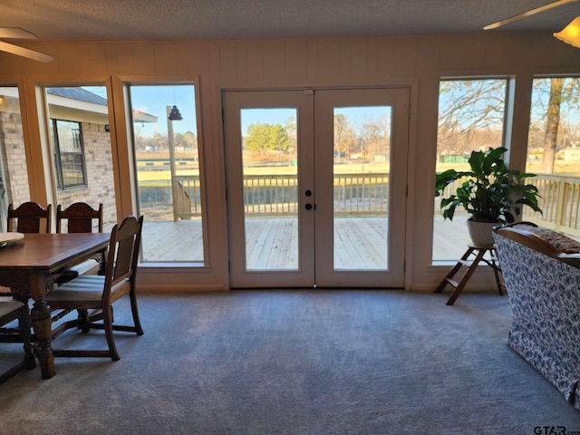 interior space featuring carpet, a textured ceiling, and french doors