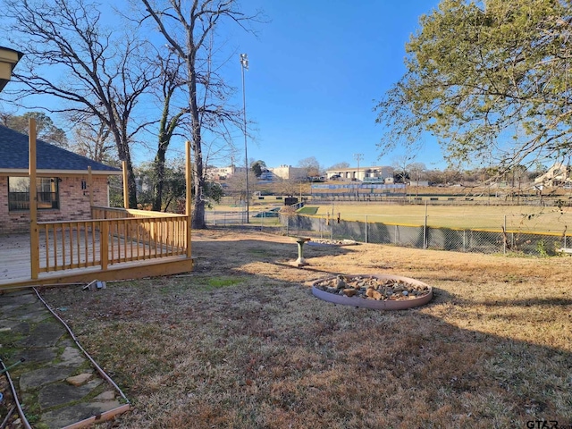 view of yard featuring fence and a wooden deck