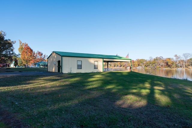 exterior space with a water view and a yard