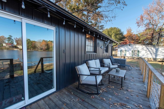 deck with a water view and an outdoor hangout area