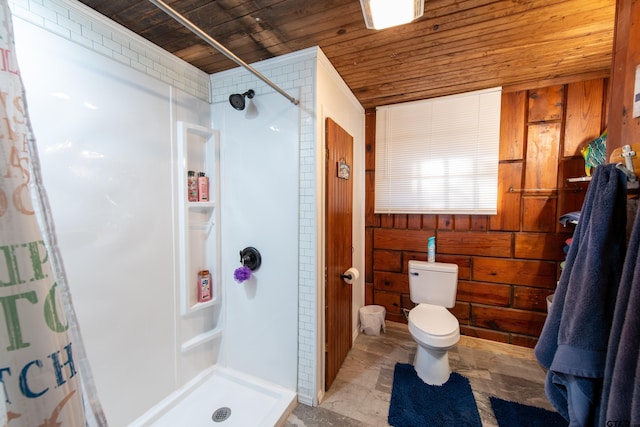 bathroom with wooden ceiling, toilet, curtained shower, and wooden walls