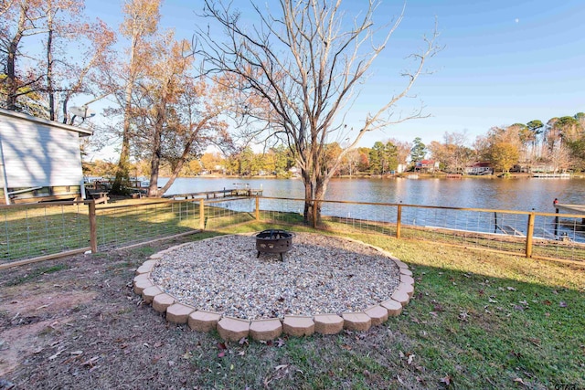 view of yard featuring a fire pit and a water view