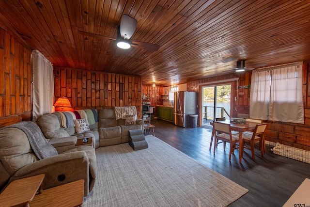 living room featuring wood walls, dark wood-type flooring, ceiling fan, and wooden ceiling