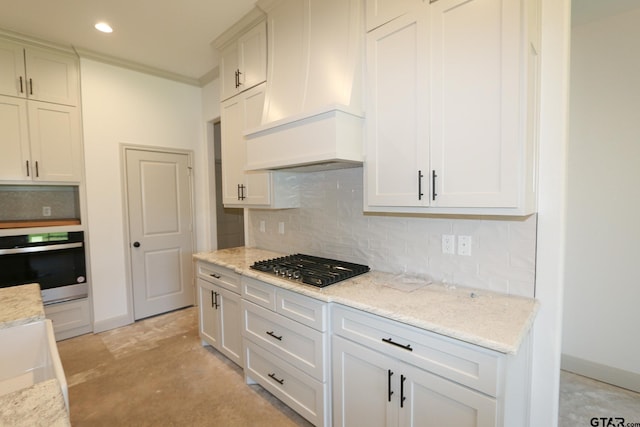 kitchen with light stone countertops, custom range hood, stainless steel appliances, and tasteful backsplash