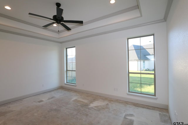 spare room with a wealth of natural light, a tray ceiling, ceiling fan, and ornamental molding