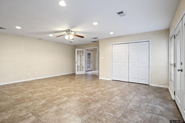 unfurnished bedroom with ceiling fan and french doors