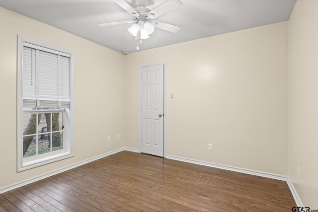 unfurnished room with ceiling fan and dark hardwood / wood-style flooring