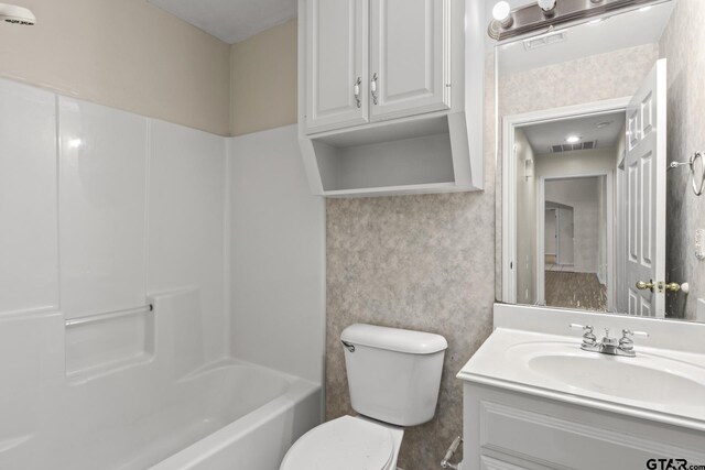 full bathroom featuring vanity, tub / shower combination, and toilet