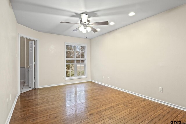 unfurnished room with wood-type flooring and ceiling fan