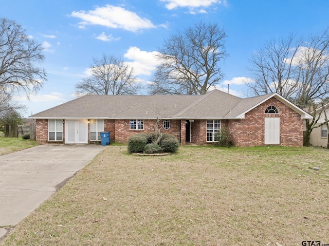 ranch-style home with a front lawn