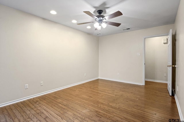 spare room featuring hardwood / wood-style floors and ceiling fan