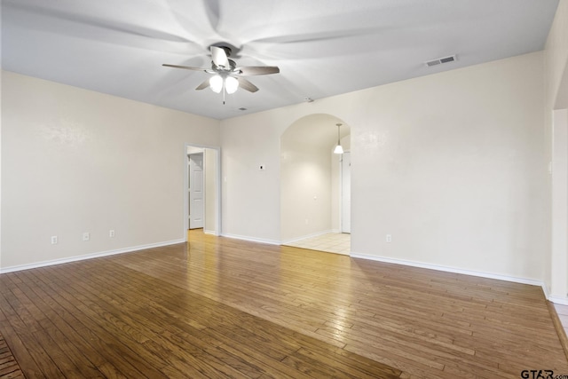 empty room featuring wood-type flooring and ceiling fan