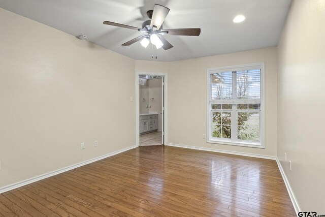 unfurnished room with ceiling fan and wood-type flooring