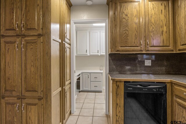 kitchen with tasteful backsplash, dishwasher, and light tile patterned floors