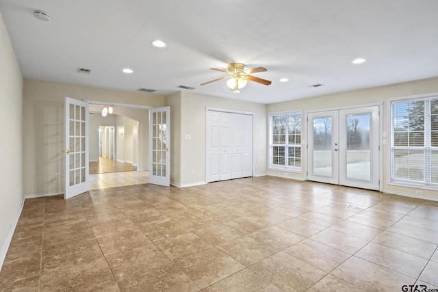 empty room with light tile patterned flooring, ceiling fan, and french doors