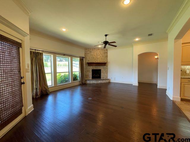 11200 Fox Trl, Flint, TX 75762 - unfurnished living room with ceiling fan, arched walkways, crown molding, wood finished floors, and recessed lighting