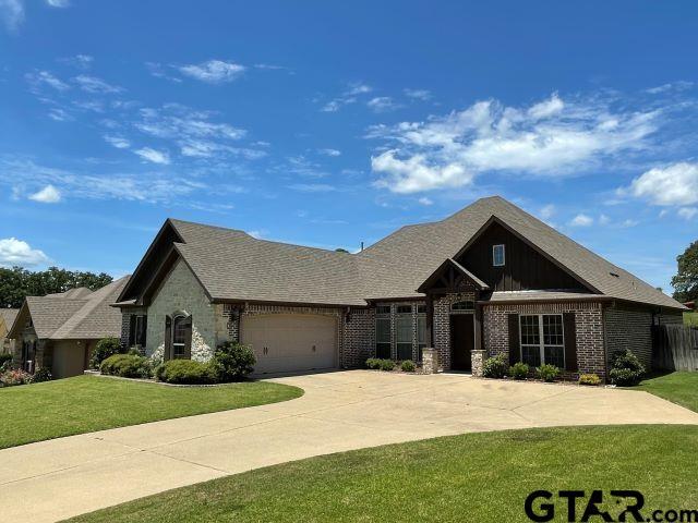 11200 Fox Trl, Flint, TX 75762 - view of front of house featuring a front yard, an attached garage, brick siding, and driveway