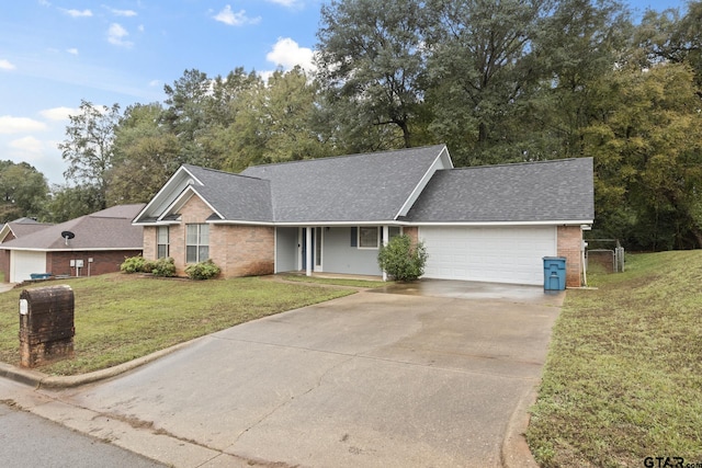 single story home with a garage and a front lawn