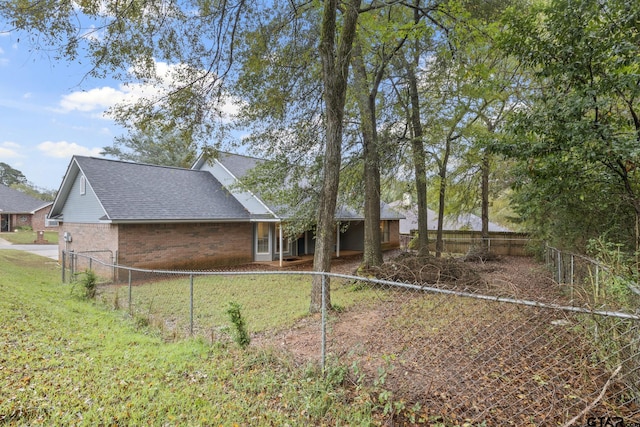 rear view of house featuring a yard