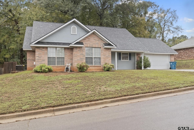 view of front of house featuring a front yard and a garage