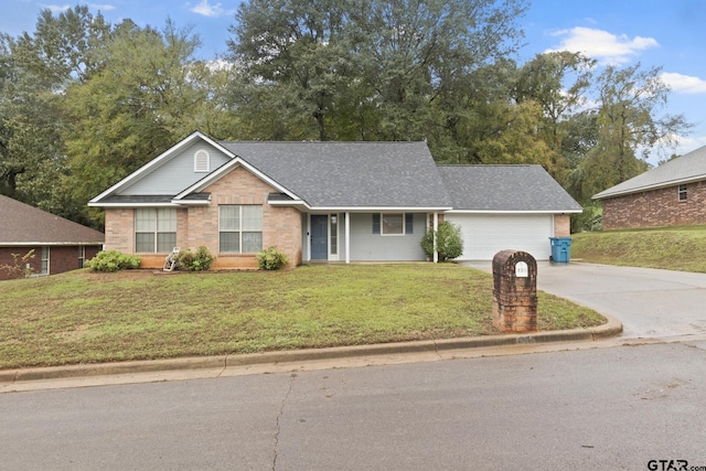 view of front of home featuring a front yard and a garage