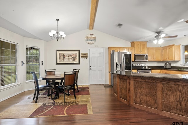 kitchen featuring ceiling fan with notable chandelier, stainless steel appliances, dark wood-type flooring, pendant lighting, and lofted ceiling with beams