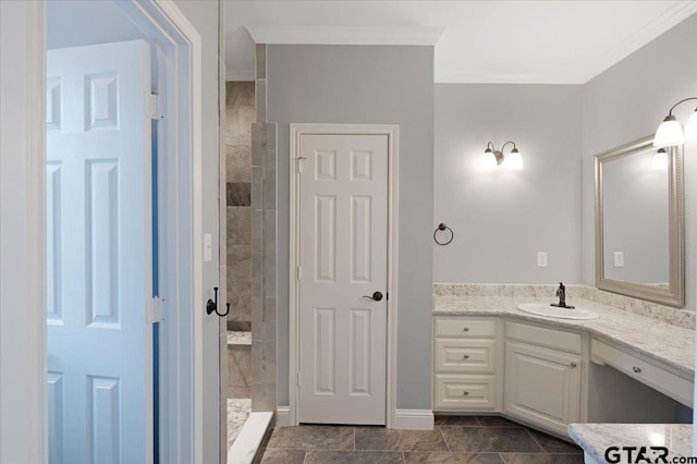 bathroom featuring vanity, tiled shower, and crown molding