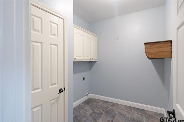 clothes washing area featuring cabinets and electric dryer hookup