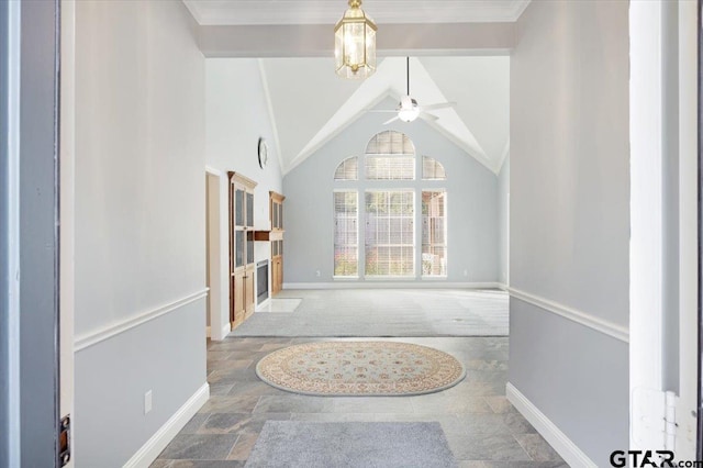 interior space featuring ceiling fan with notable chandelier, vaulted ceiling with beams, and crown molding