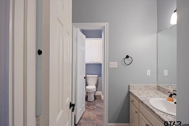 bathroom with toilet and vanity