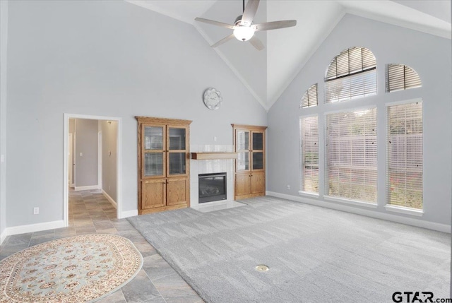 living room with high vaulted ceiling, a wealth of natural light, light carpet, and ceiling fan