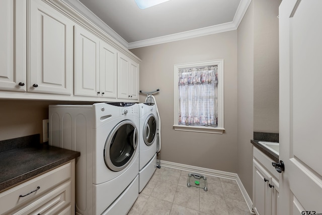 laundry area featuring cabinets, ornamental molding, light tile patterned floors, and washing machine and clothes dryer