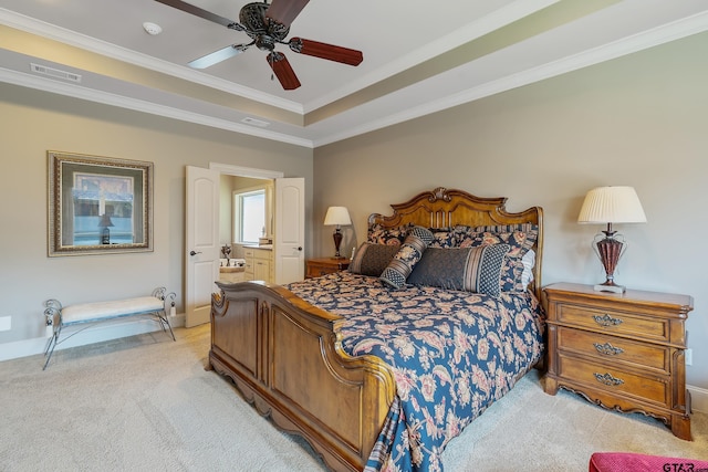 carpeted bedroom with ceiling fan, ornamental molding, connected bathroom, and a tray ceiling