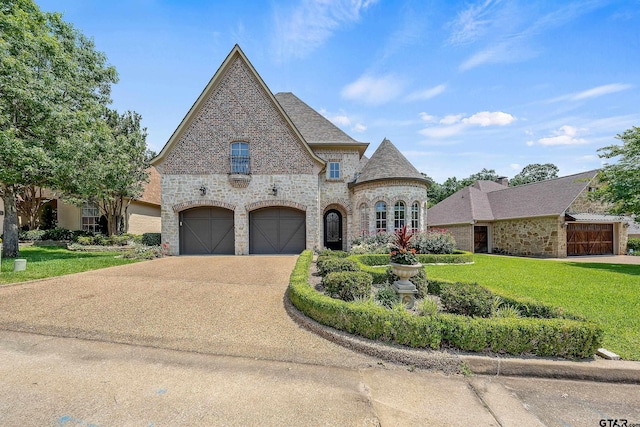 french provincial home with a garage and a front lawn