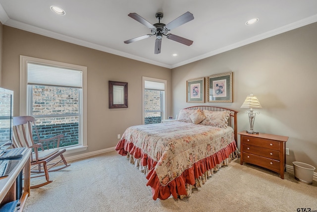 bedroom with light colored carpet, ceiling fan, and crown molding