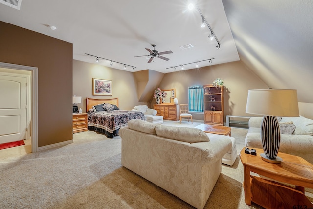 carpeted bedroom with track lighting, ceiling fan, and lofted ceiling