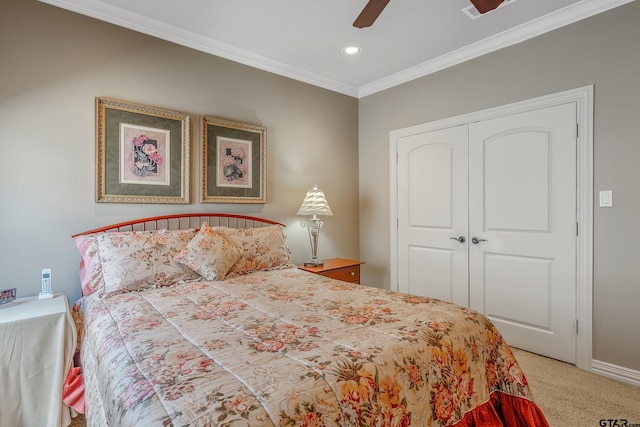 bedroom featuring carpet, a closet, ceiling fan, and crown molding